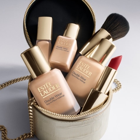 A collection of Estee Lauder complexion products in a cosmetics bag 